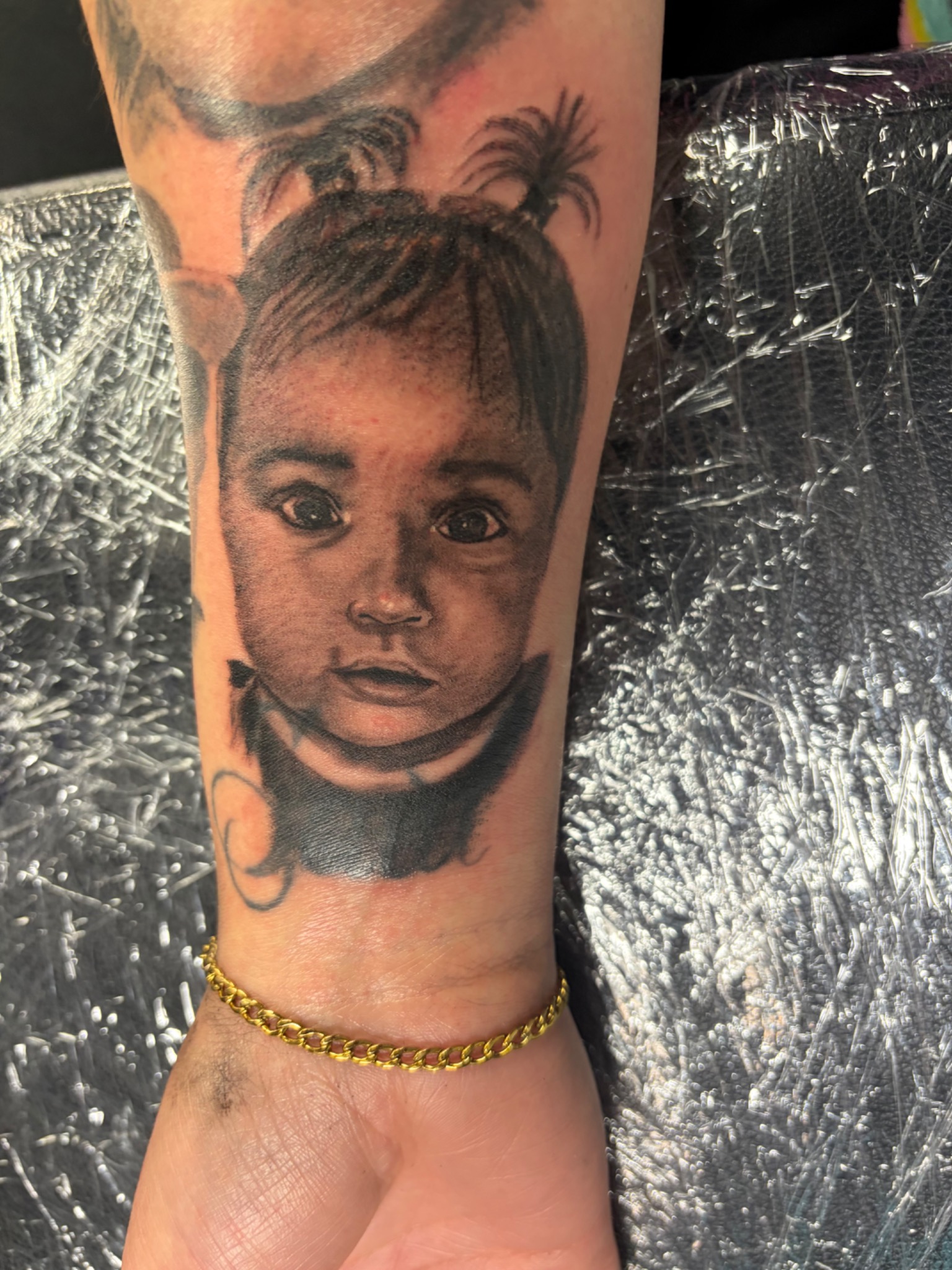 Black and grey child memorial portrait tattoo