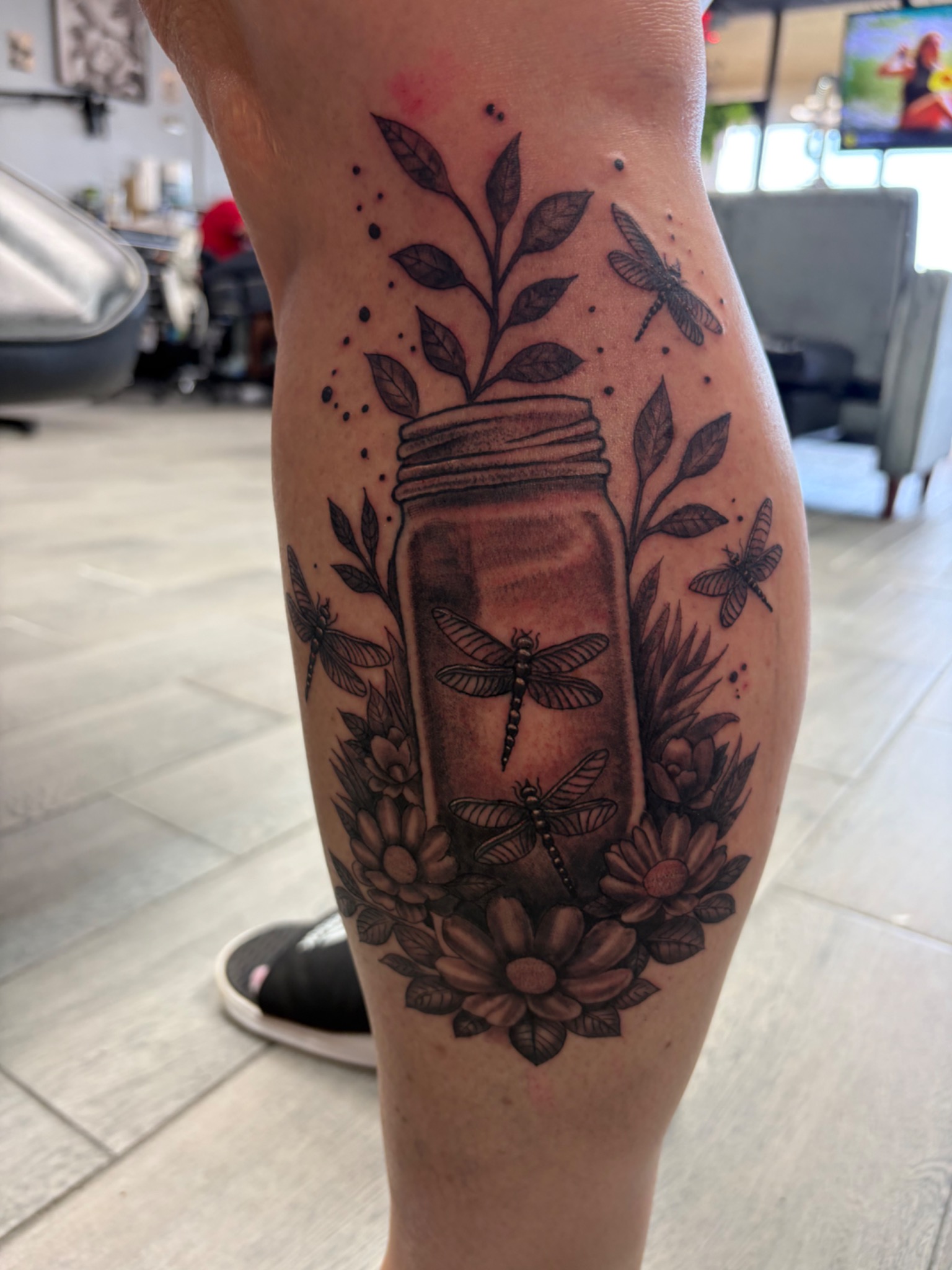Black and grey jar dragonflies and flowers tattoo