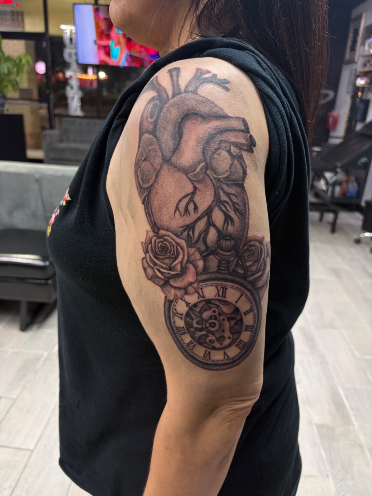 Anatomical heart roses and clock upper arm tattoo