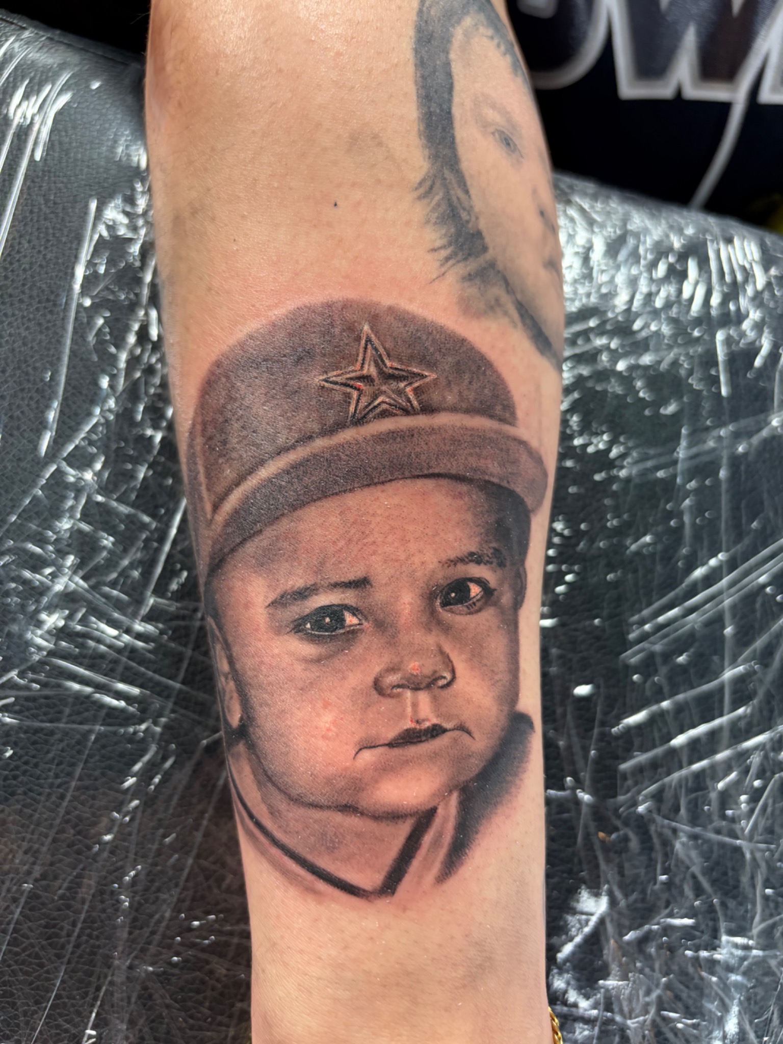 Black and grey child portrait with Dallas star cap tattoo