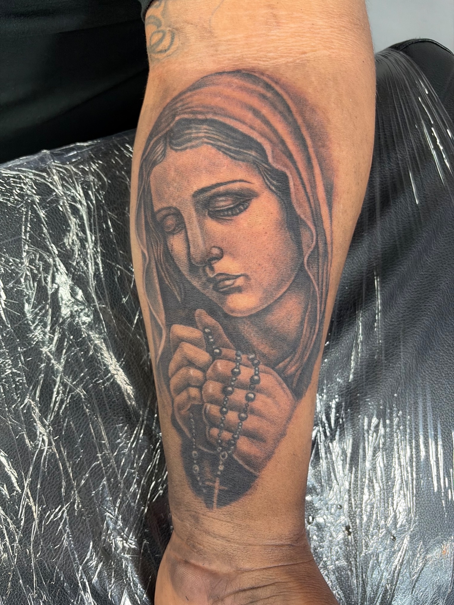 Black and grey praying Mary portrait tattoo
